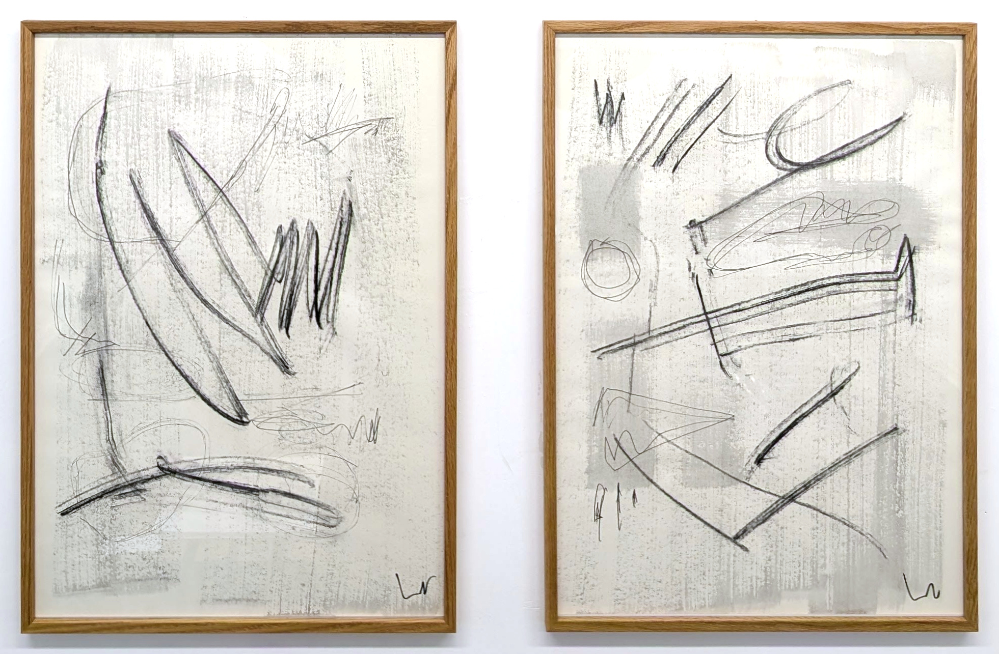 NOBU charcoal diptych, both framed panels shown together in their original left-to-right order.